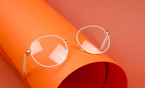 Close-up of sunglasses on red background