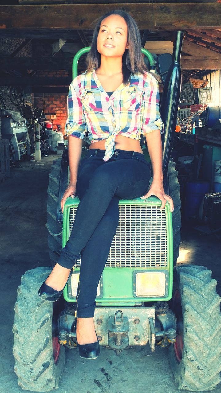 person, casual clothing, lifestyles, young adult, full length, sitting, leisure activity, front view, looking at camera, portrait, young women, three quarter length, indoors, chair, smiling, holding, sunglasses, standing