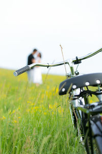 Bicycle on field against clear sky