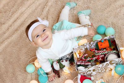 High angle portrait of cute baby boy with toy