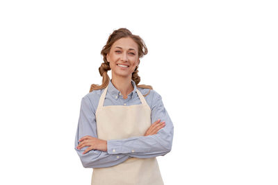 Portrait of a smiling young woman against white background