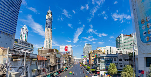 Buildings in city against blue sky