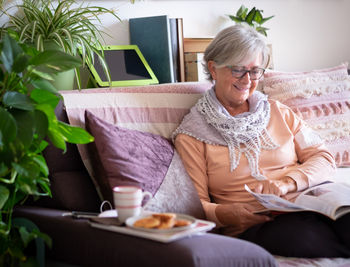 Woman sitting on chair at home