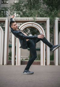 Full length of young man dancing on walkway