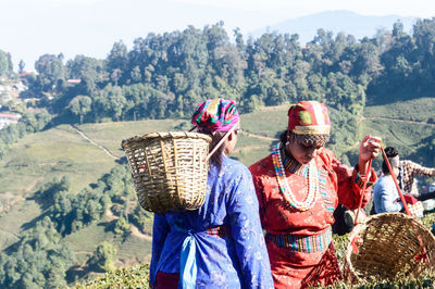 Rear view of people in basket against mountain