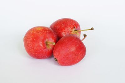 High angle view of cherries on white background