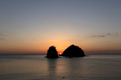 Scenic view of sea against romantic sky at sunset