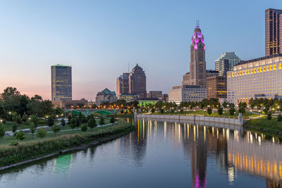 Reflection of buildings in city at waterfront