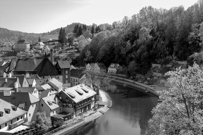 High angle view of townscape by river against sky