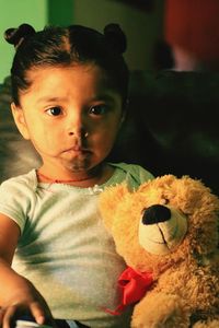 Portrait of cute baby girl with teddy bear