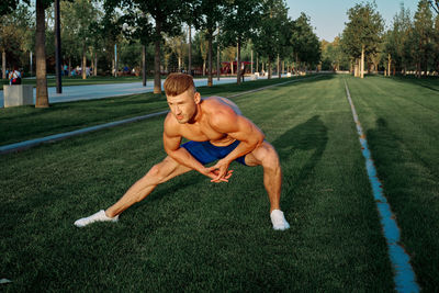 Full length of senior man sitting on grass