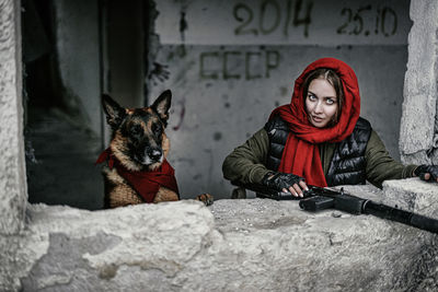 Portrait of woman with dog sitting in winter