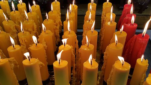 Close-up of lit candle in darkroom