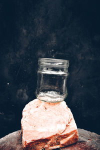 Close-up of drink in glass jar on table against wall
