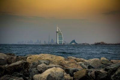 Sailboat on sea against sky during sunset