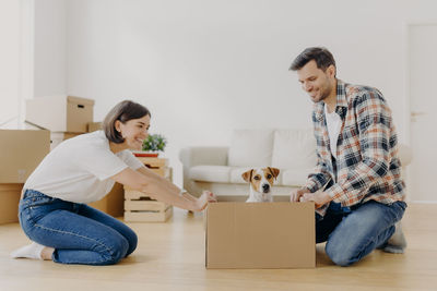 Couple sitting by box