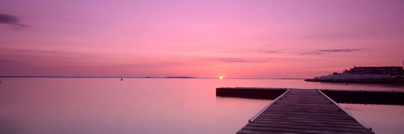 Scenic view of sea against sky at sunset