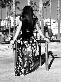 Woman leaning on railing in city