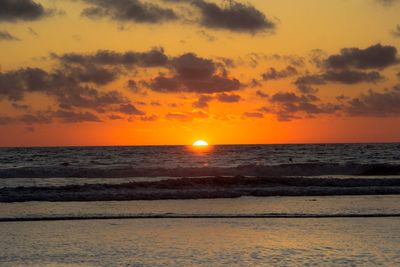 Scenic view of sea against orange sky