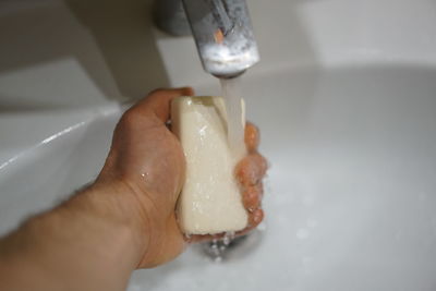 Close-up of hand holding ice cream