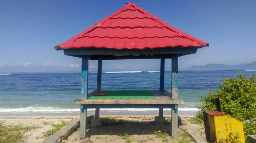Lifeguard hut on beach against sky