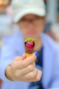 Cropped hand holding ice cream cone