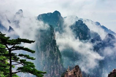 Scenic view of mountains against cloudy sky