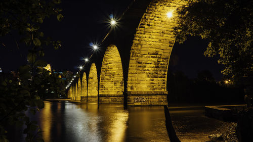 Low angle view of bridge illuminated at night