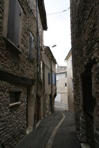 Narrow street amidst old buildings in city