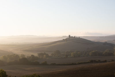 Scenic view of landscape against sky during foggy weather