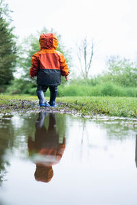 Toddler playing in puddle