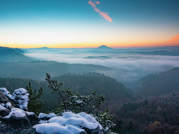 Snowy peak early morning. chill awaking in misty country. morning sun hidden bellow horizon