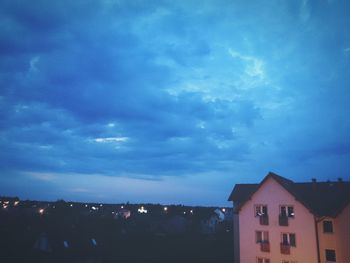 View of buildings against cloudy sky