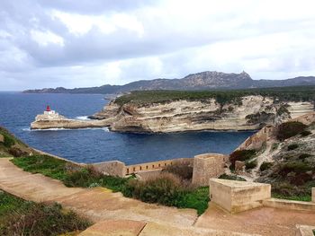 Scenic view of sea and mountains against sky