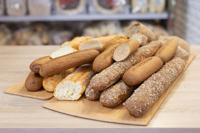 Various types of baguettes placed on a wooden tray.