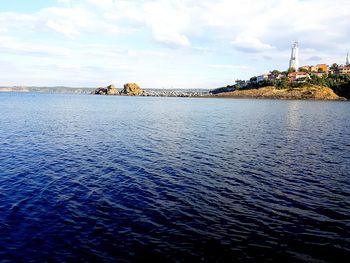 Scenic view of sea against sky in city