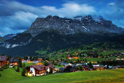 Town by mountains against sky