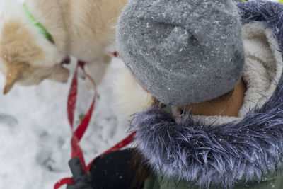 High angle view of woman with dog during winter