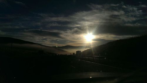 Scenic view of mountains against sky at sunset