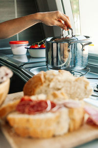 A young woman having breakfast in her caravan observing a good view of the beach