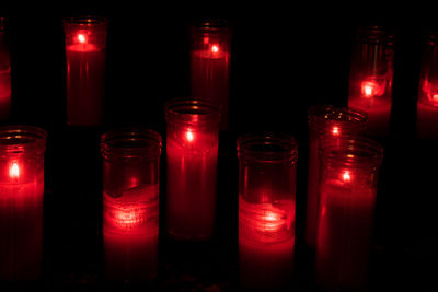 Close-up of lit candles in the dark
