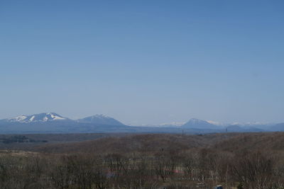 Scenic view of mountains against clear blue sky