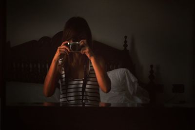 Young woman using camera