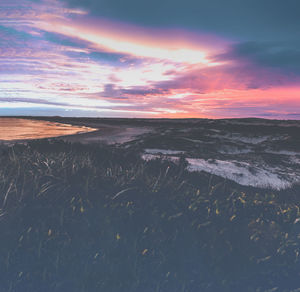 Scenic view of beach against sky during sunset