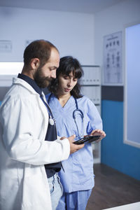 Female doctor examining x-ray at clinic