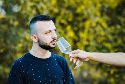 Young man drinking glass with drink