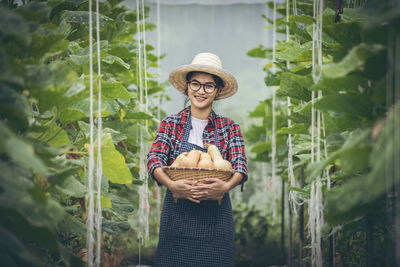 Portrait of a smiling young woman holding food outdoors