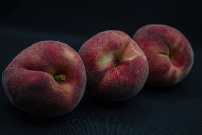 Close-up of apples on table against black background