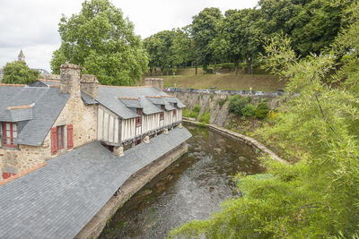 Building by river against sky