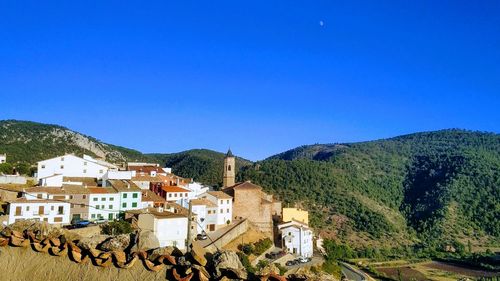 Buildings against clear blue sky